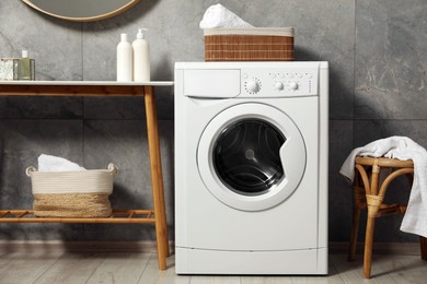 Photo of Washing machine, storage bench and chair indoors