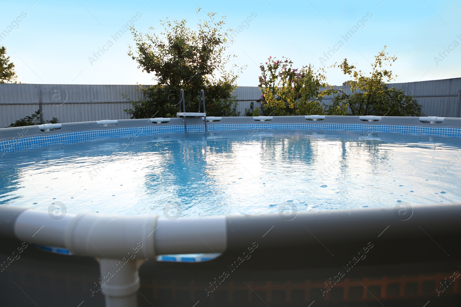 Photo of Above ground swimming pool in garden, closeup