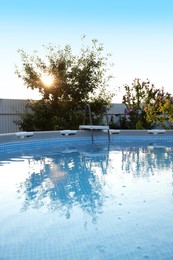 Above ground swimming pool outdoors on sunny day