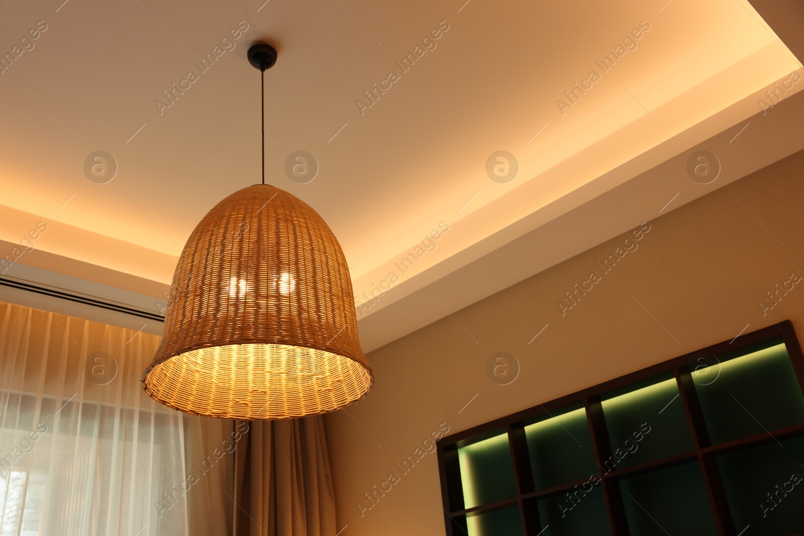 Photo of Stylish pendant lamp on ceiling indoors, low angle view