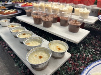 Photo of Different tasty desserts on table. Buffet service