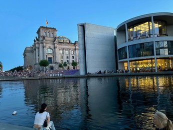 Berlin, Germany - July 30, 2024: Picturesque view of Paul-Loebe-Haus and Reichstag building near river outdoors