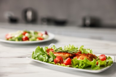 Photo of Delicious dish with chicken on white marble table, closeup