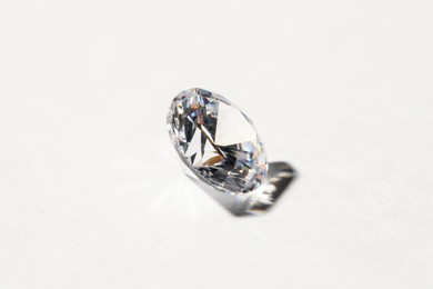 Photo of Beautiful shiny diamond on white background, closeup