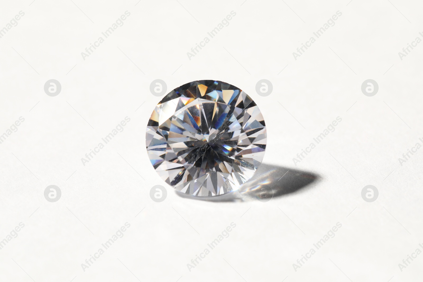 Photo of Beautiful shiny diamond on white background, closeup