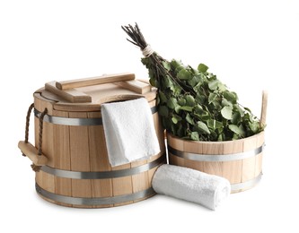 Photo of Sauna equipment. Wooden buckets, birch whisk and towels isolated on white