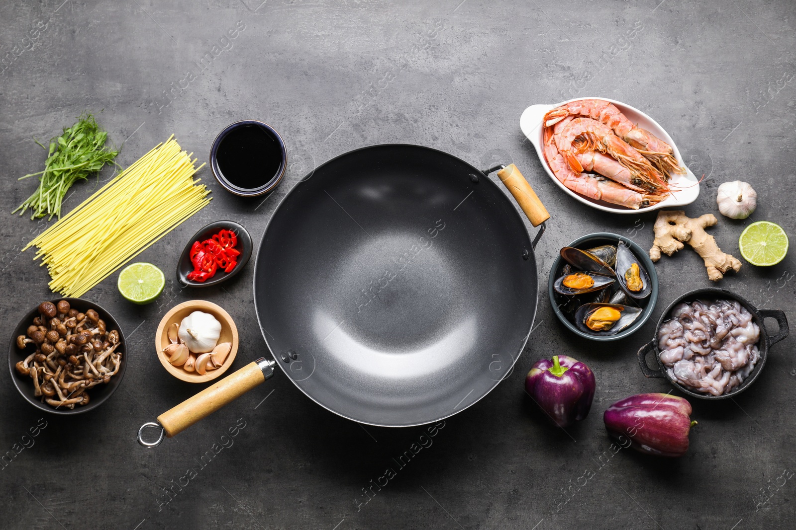 Photo of Ingredients for wok on grey table, flat lay