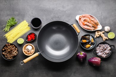 Photo of Ingredients for wok on grey table, flat lay