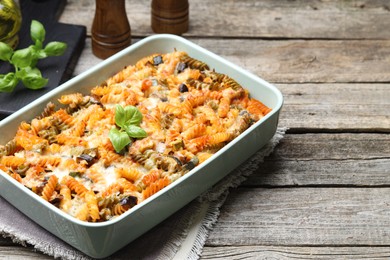 Photo of Delicious al forno pasta in baking dish on wooden table