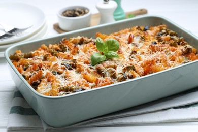 Photo of Delicious al forno pasta in baking dish on white wooden table, closeup