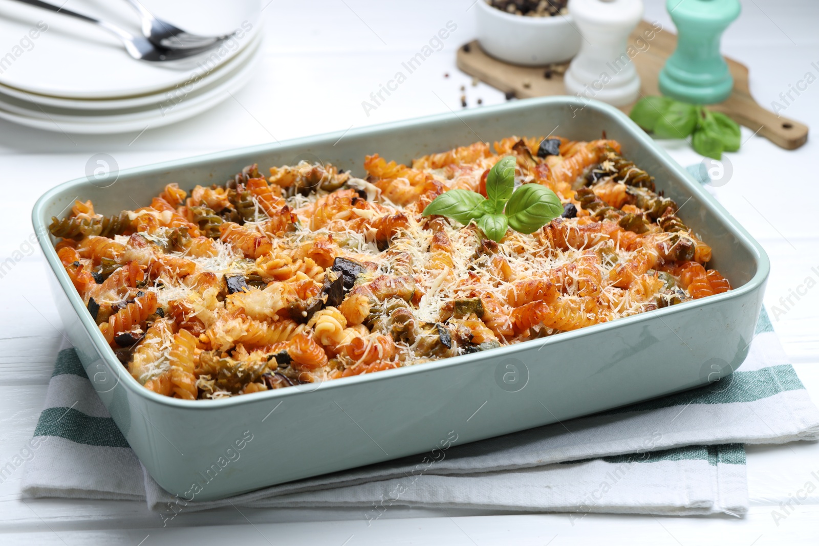 Photo of Delicious al forno pasta in baking dish on white wooden table