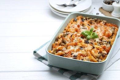 Photo of Delicious al forno pasta in baking dish on white wooden table