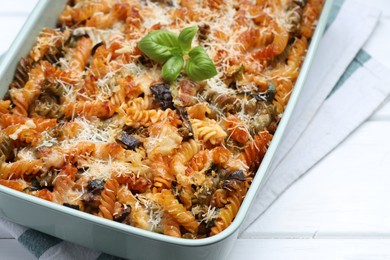 Photo of Delicious al forno pasta in baking dish on white wooden table, closeup