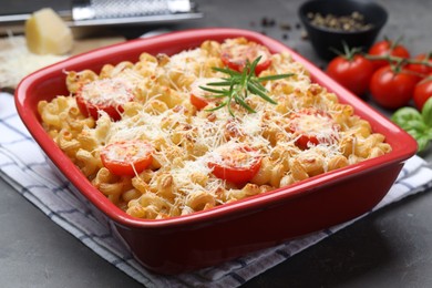 Delicious al forno pasta in baking dish on grey table, closeup