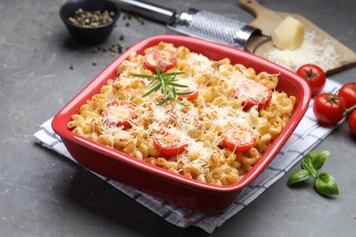 Photo of Delicious al forno pasta in baking dish on grey table