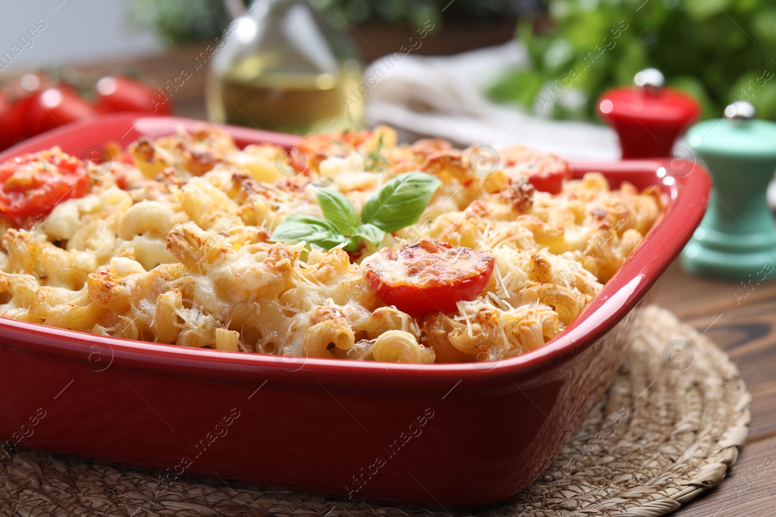 Photo of Delicious al forno pasta in baking dish on wooden table, closeup