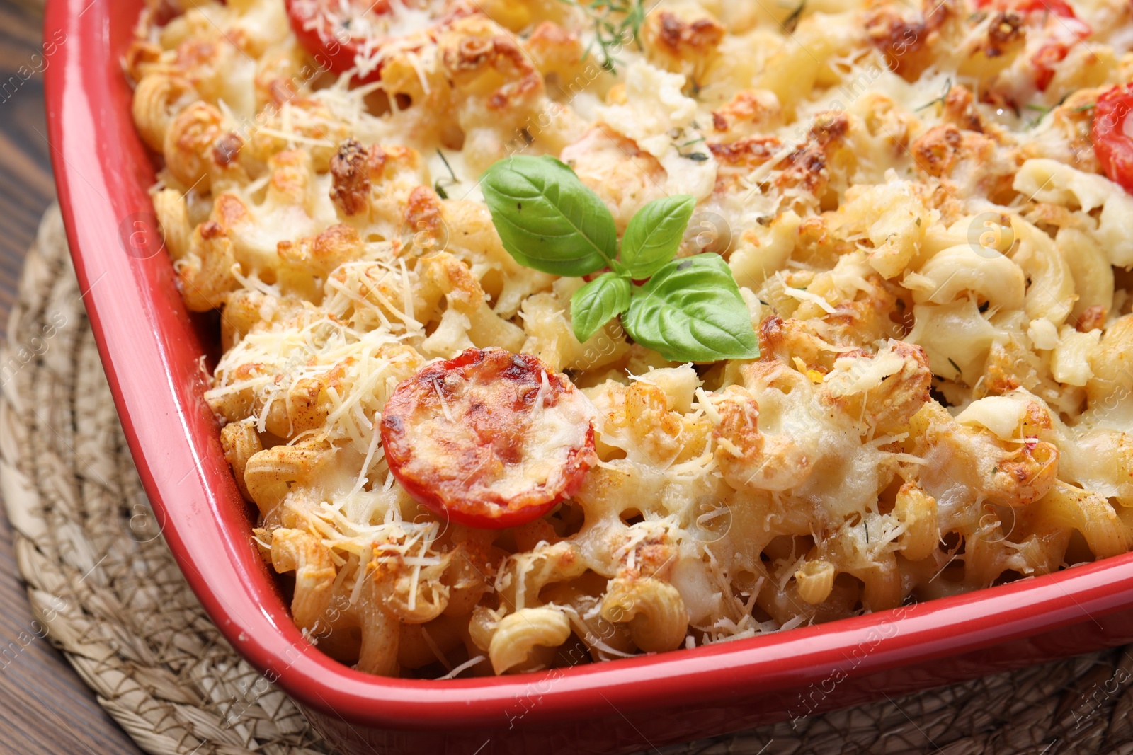 Photo of Delicious al forno pasta in baking dish on wooden table, closeup