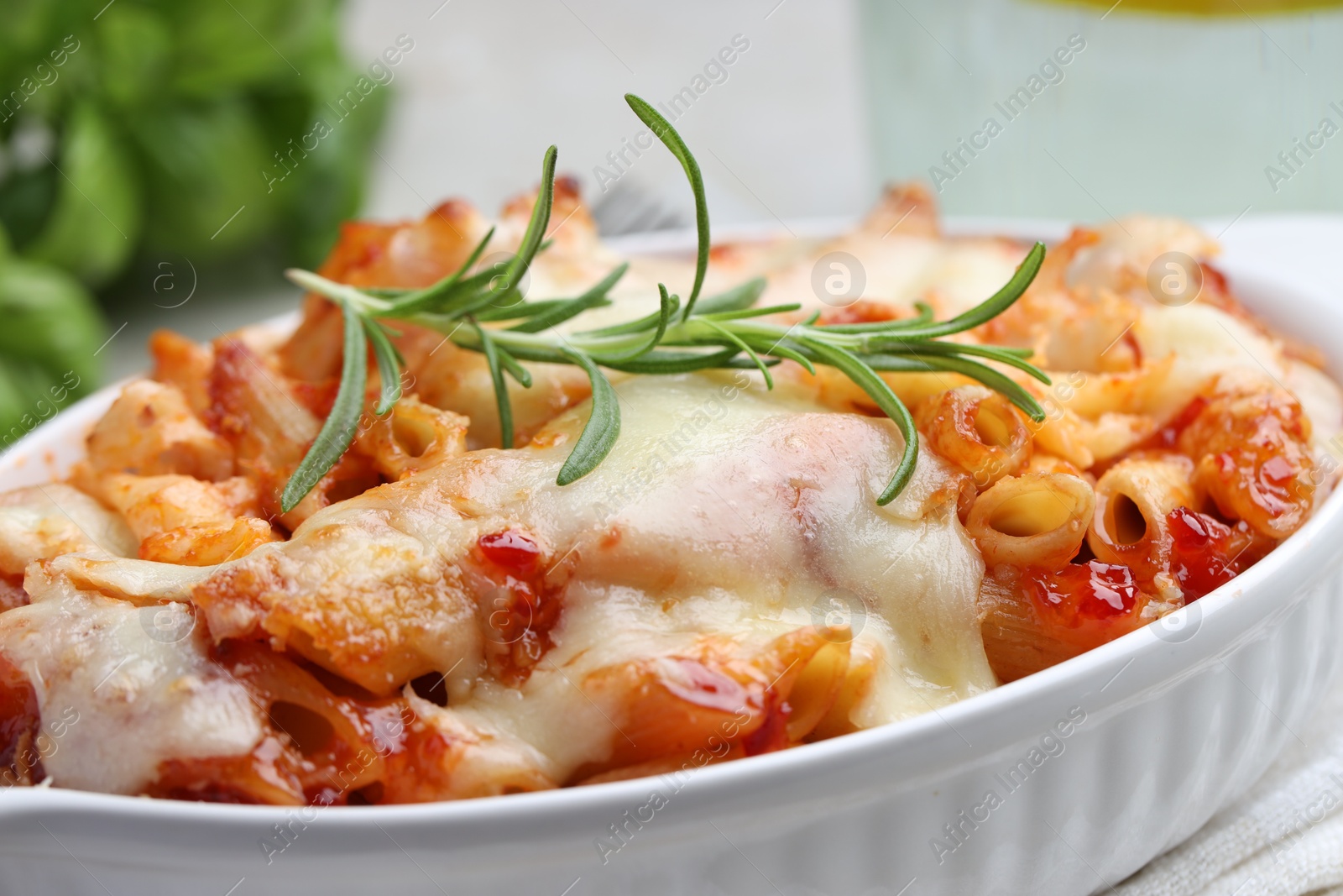 Photo of Delicious al forno pasta in baking dish on table, closeup