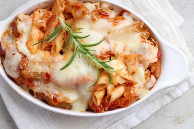 Photo of Delicious al forno pasta in baking dish on light table, top view