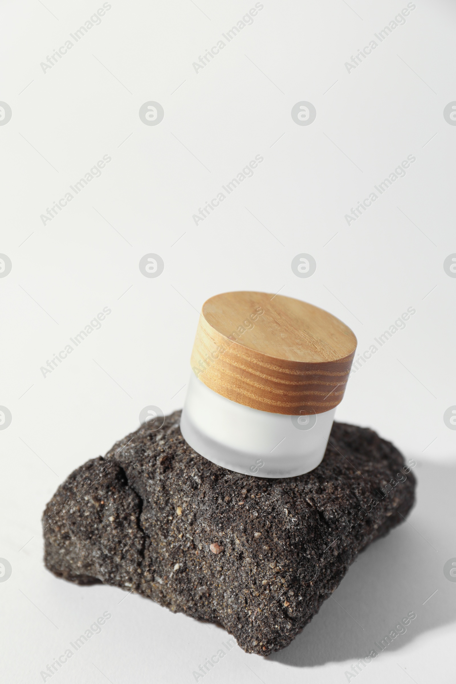 Photo of Stylish presentation of facial cream on beige background