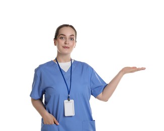 Professional nurse with badge pointing at something on white background