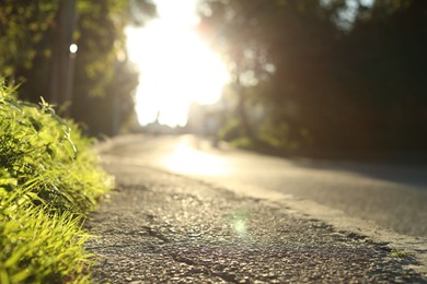 Photo of View of asphalt road and trees in morning