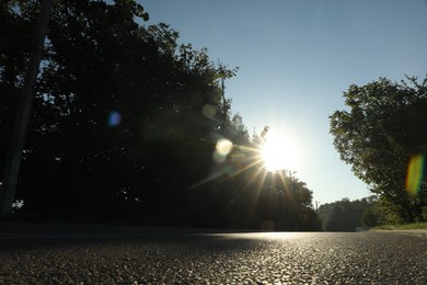 Photo of View of asphalt road and trees in morning