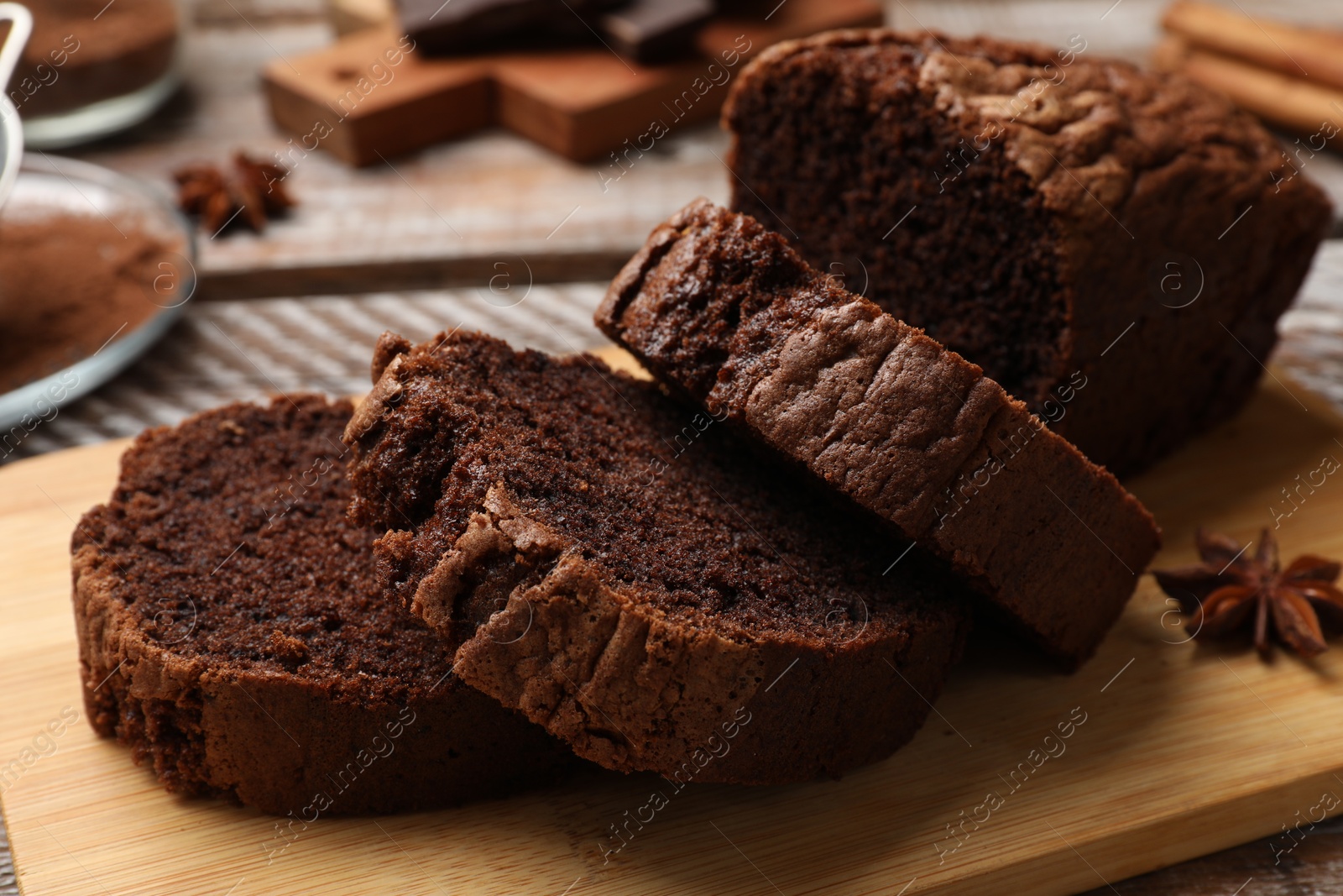 Photo of Delicious cut chocolate sponge cake on wooden table, closeup