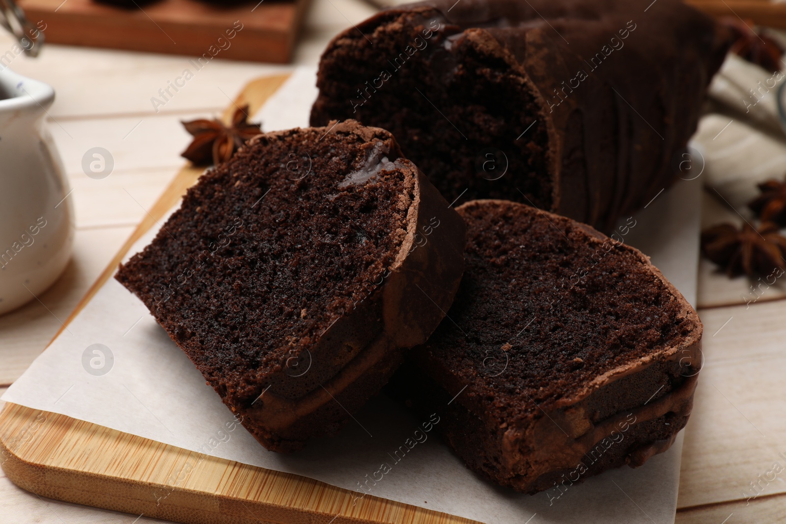 Photo of Delicious chocolate sponge cake on white wooden table, closeup