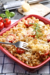 Photo of Delicious al forno pasta in baking dish on table, closeup