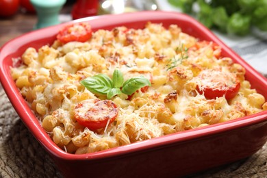 Photo of Delicious al forno pasta in baking dish on wooden table, closeup