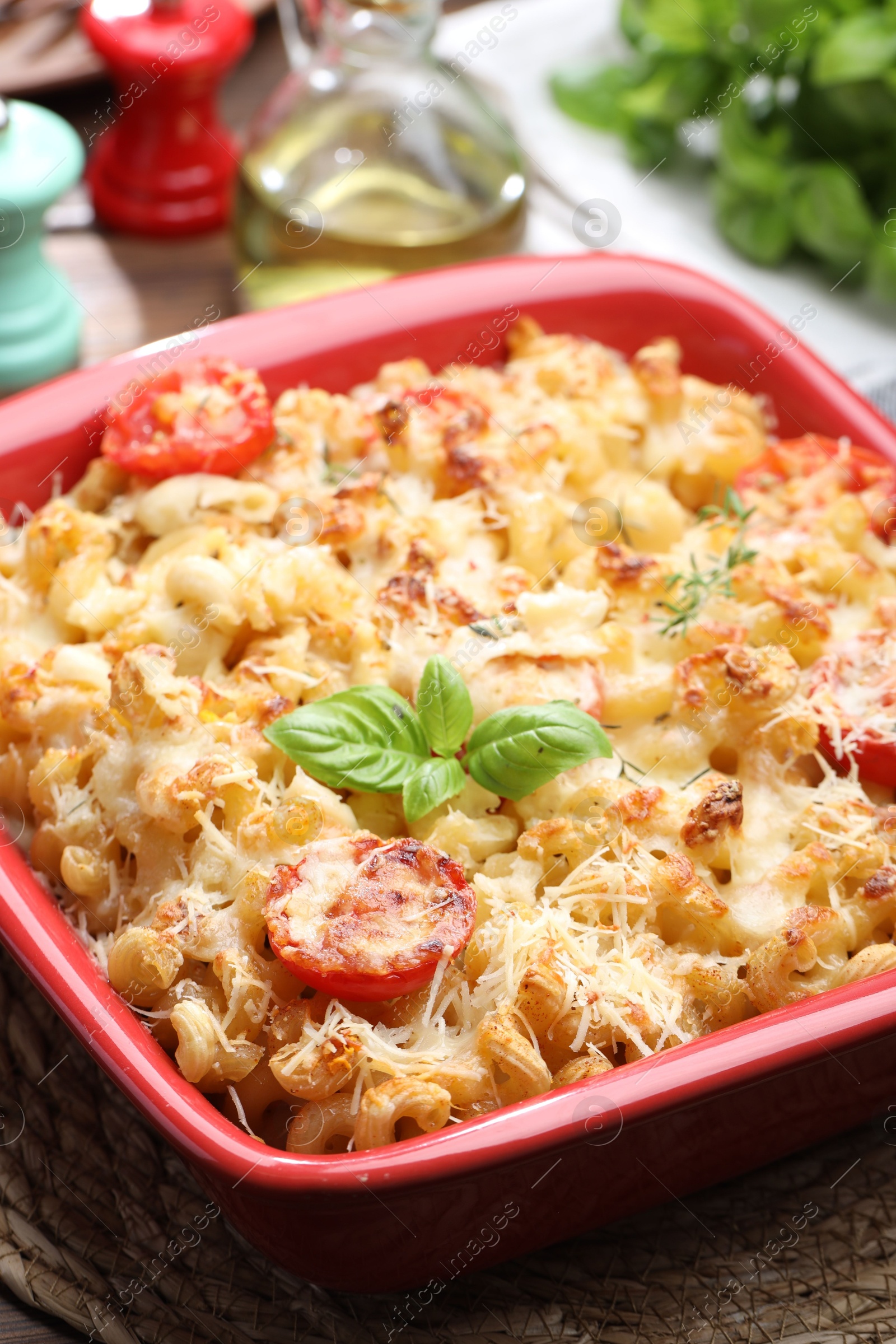 Photo of Delicious al forno pasta in baking dish on wooden table, closeup