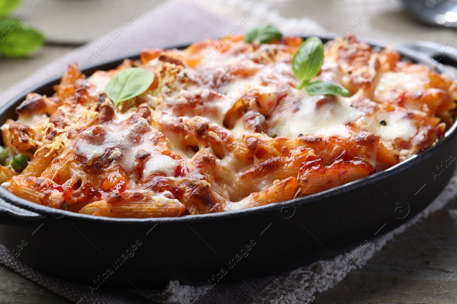 Photo of Delicious al forno pasta in baking dish on table, closeup