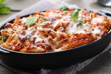 Photo of Delicious al forno pasta in baking dish on table, closeup