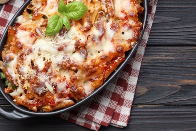 Photo of Delicious al forno pasta in baking dish on wooden table, top view