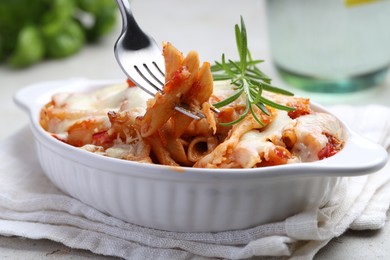 Photo of Delicious al forno pasta in baking dish on light table