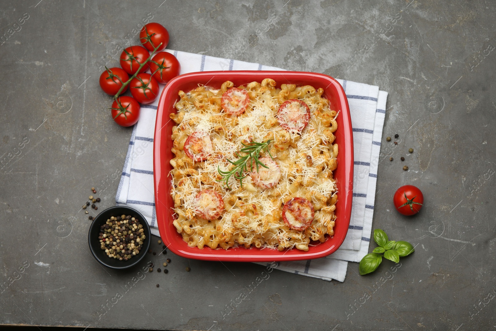 Photo of Delicious al forno pasta in baking dish on grey table, flat lay