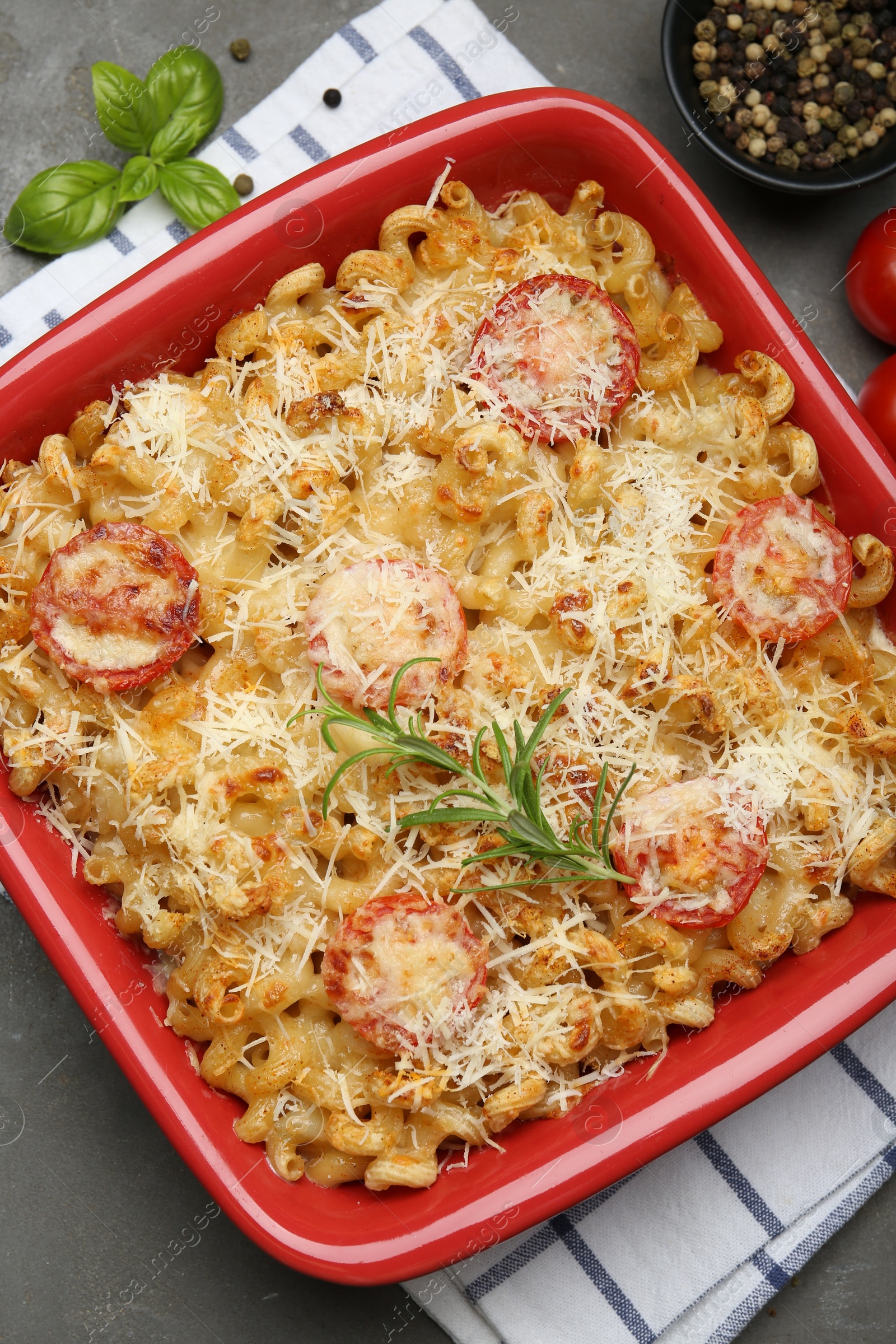 Photo of Delicious al forno pasta in baking dish on grey table, flat lay