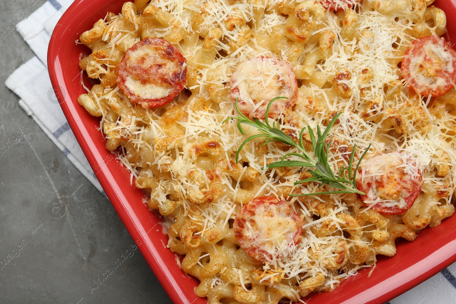 Photo of Delicious al forno pasta in baking dish on grey table, top view