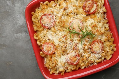 Photo of Delicious al forno pasta in baking dish on grey table, top view