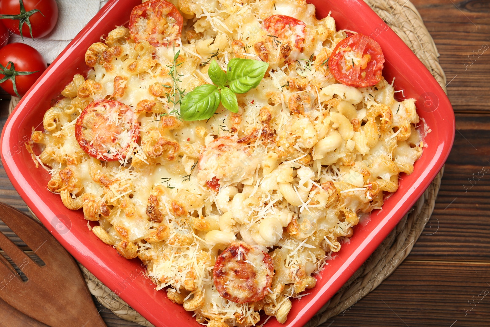 Photo of Delicious al forno pasta in baking dish on wooden table, top view