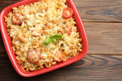 Photo of Delicious al forno pasta in baking dish on wooden table, top view