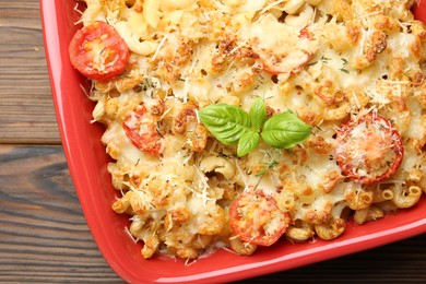 Delicious al forno pasta in baking dish on wooden table, top view