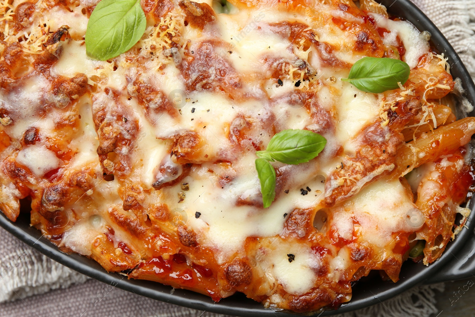 Photo of Delicious al forno pasta in baking dish on wooden table, top view