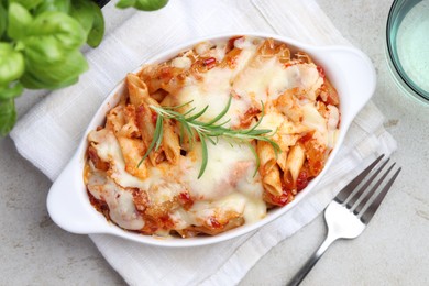 Photo of Delicious al forno pasta in baking dish on light table, top view