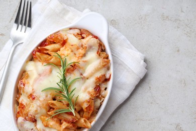 Photo of Delicious al forno pasta in baking dish on light table, top view