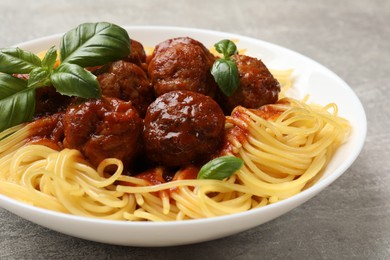 Delicious pasta with meatballs on grey table, closeup