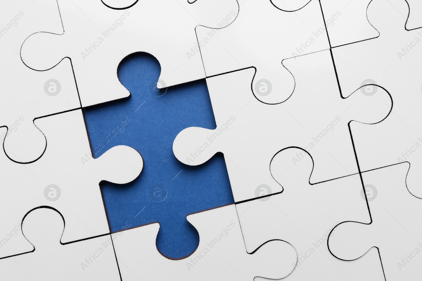 Photo of White puzzle with missing piece on blue background, top view