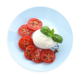 Delicious burrata cheese, tomatoes, basil and spices isolated on white, top view