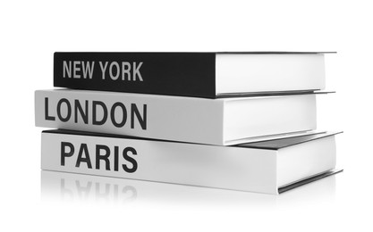 Stack of hardcover books with different cities names isolated on white